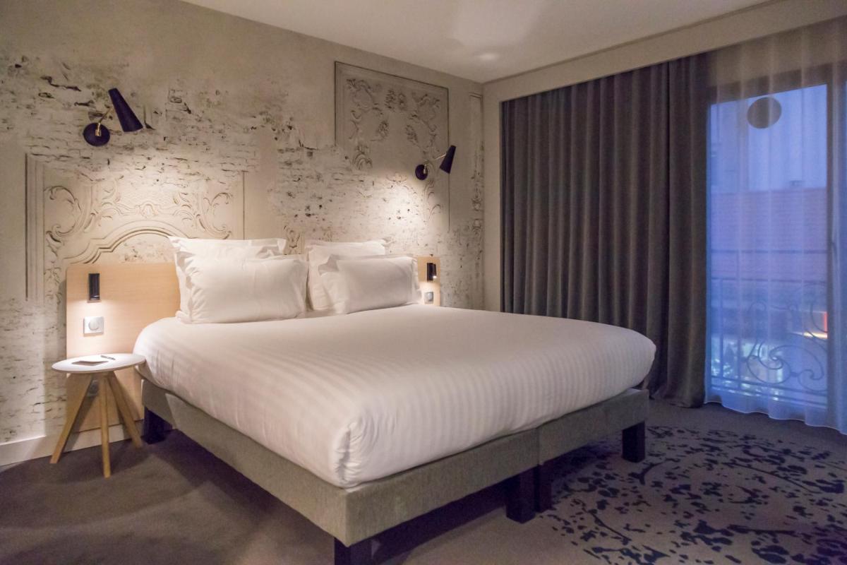 Un ou plusieurs lits dans un hébergement de l'établissement Nemea Appart Hotel Cannes Palais