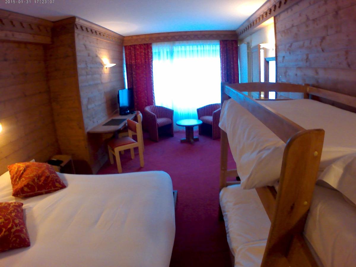 Un ou plusieurs lits dans un hébergement de l'établissement Hotel le Chalet