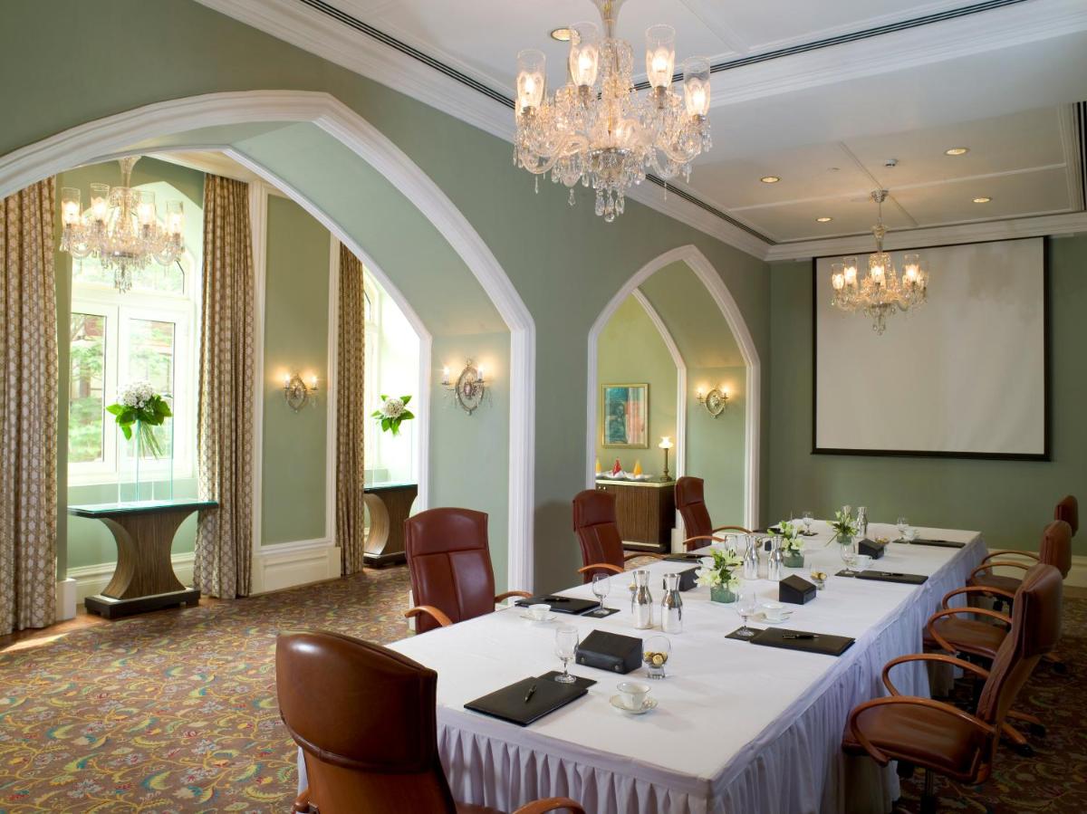 a conference room with tables and chairs and a chandelier at The Taj Mahal Tower, Mumbai in Mumbai a conference room with tables and chairs and a chandelier at The Taj Mahal Tower, Mumbai in Mumbai