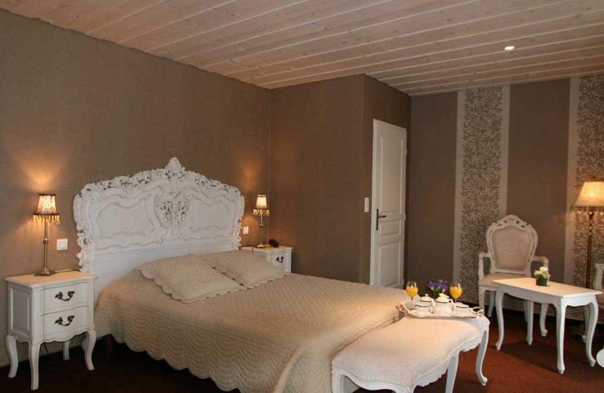 Un ou plusieurs lits dans un hébergement de l'établissement Hôtel Restaurant Taillard