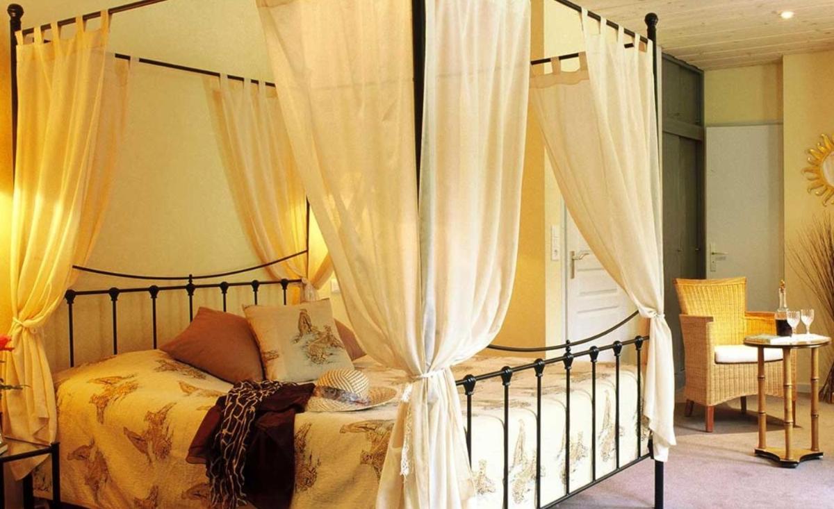 Un ou plusieurs lits dans un hébergement de l'établissement Hôtel Restaurant Taillard