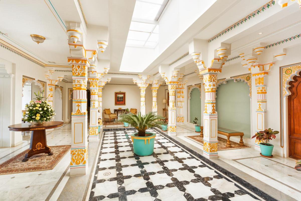 an ornate lobby with columns and potted plants at Taj Fateh Prakash Palace Udaipur in Udaipur