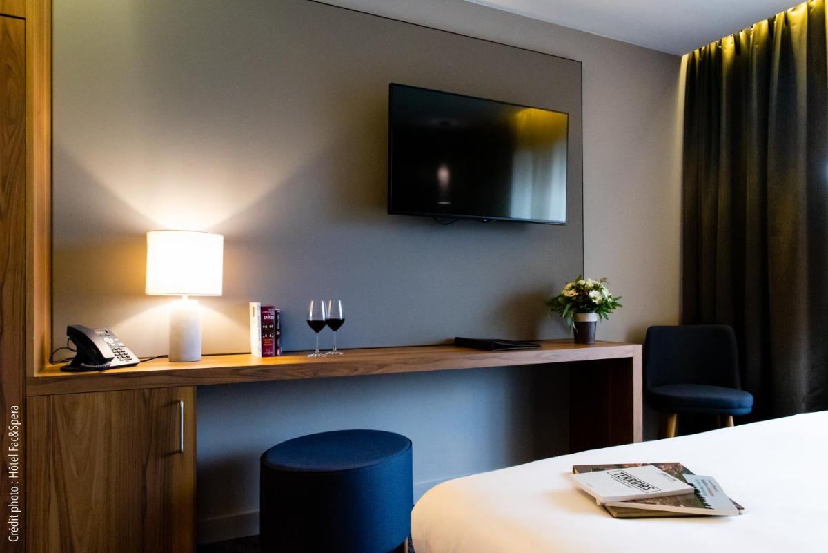 Un ou plusieurs lits dans un hébergement de l'établissement Fac & Spera -Hôtel & Spa