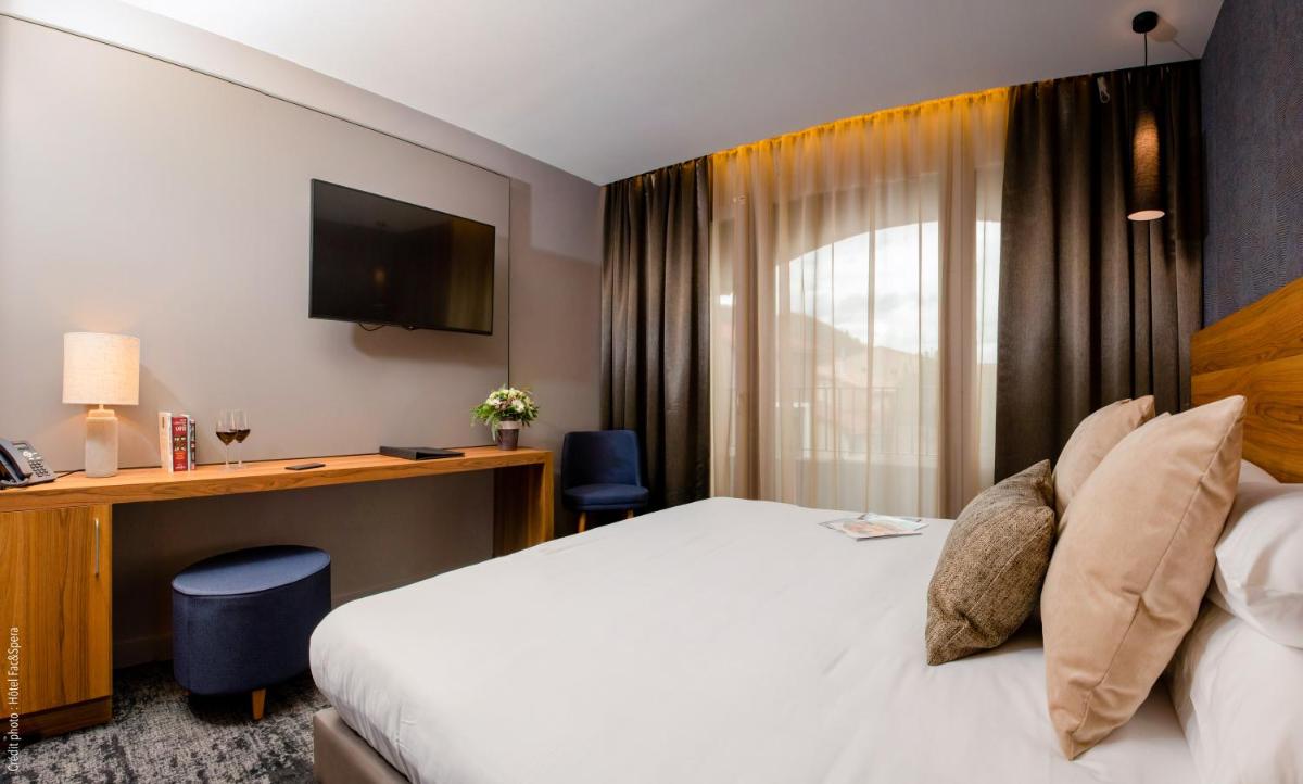 Un ou plusieurs lits dans un hébergement de l'établissement Fac & Spera -Hôtel & Spa