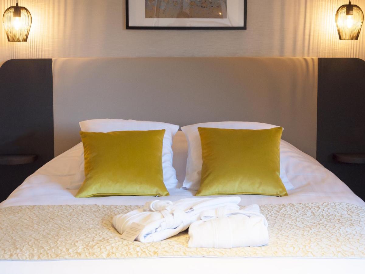 Un ou plusieurs lits dans un hébergement de l'établissement Hotel Restaurant & Spa Verte Vallée
