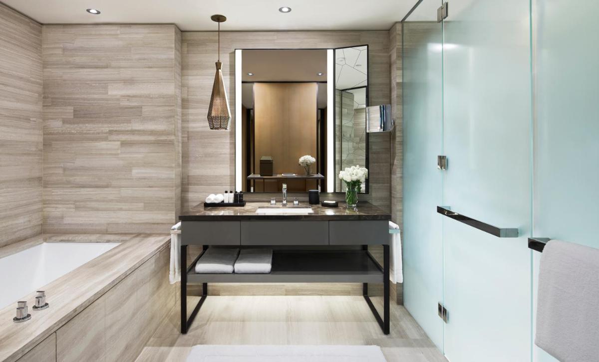 a bathroom with a sink and a mirror at Four Seasons Hotel Bengaluru at Embassy ONE in Bengaluru a bathroom with a sink and a mirror at Four Seasons Hotel Bengaluru at Embassy ONE in Bengaluru