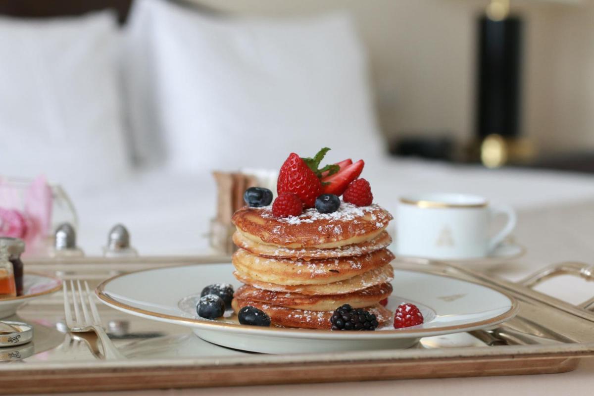 a stack of pancakes with strawberries and blueberries on a tray at Four Seasons Hotel Bengaluru at Embassy ONE in Bengaluru a stack of pancakes with strawberries and blueberries on a tray at Four Seasons Hotel Bengaluru at Embassy ONE in Bengaluru