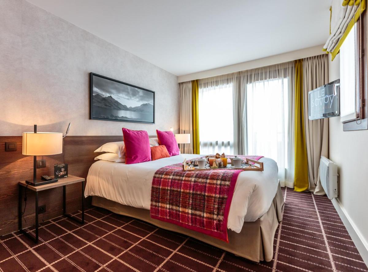 Un ou plusieurs lits dans un hébergement de l'établissement Hotel Le Savoy