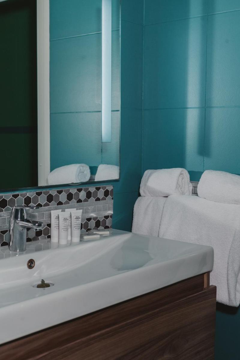 Un ou plusieurs lits dans un hébergement de l'établissement Ostella Spa & Resort