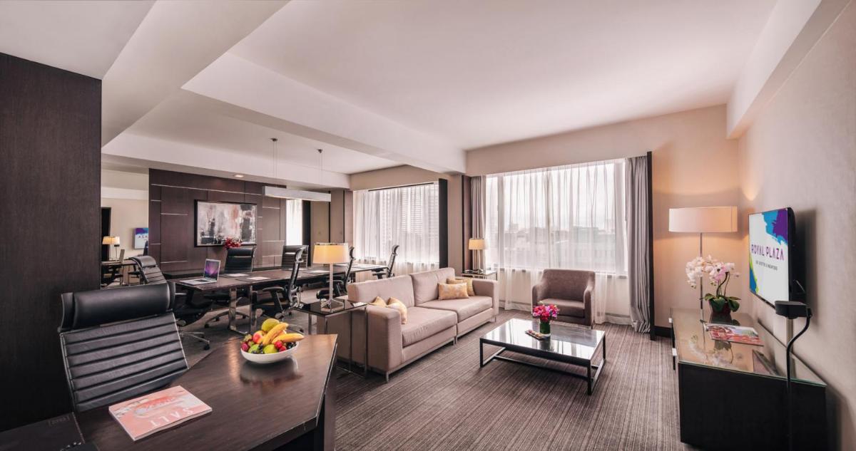a living room with a couch and a table at Royal Plaza on Scotts in Singapore