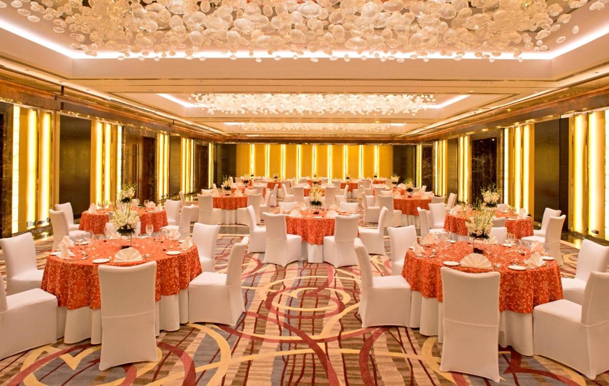 a ballroom with tables and chairs in a room with yellow walls at Radisson Blu Plaza Delhi Airport in New Delhi +238 photos a ballroom with tables and chairs in a room with yellow walls at Radisson Blu Plaza Delhi Airport in New Delhi +238 photos