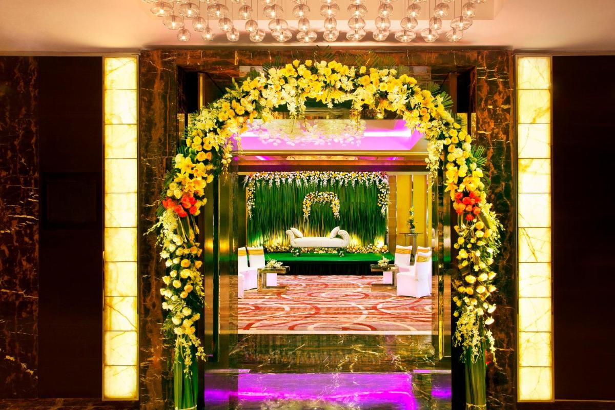 a room with an arch with flowers on it at Radisson Blu Plaza Delhi Airport in New Delhi a room with an arch with flowers on it at Radisson Blu Plaza Delhi Airport in New Delhi