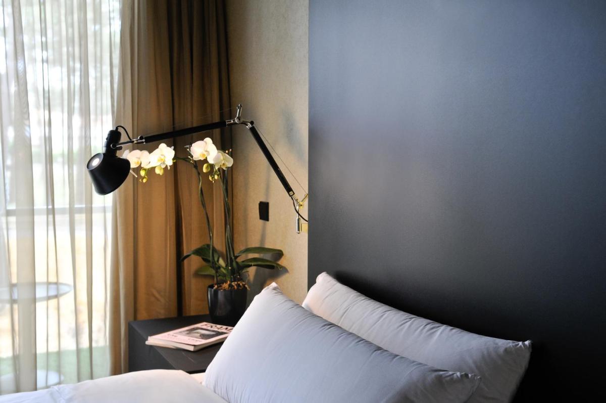 Uma cama ou camas num quarto em Evidencia Belverde Hotel