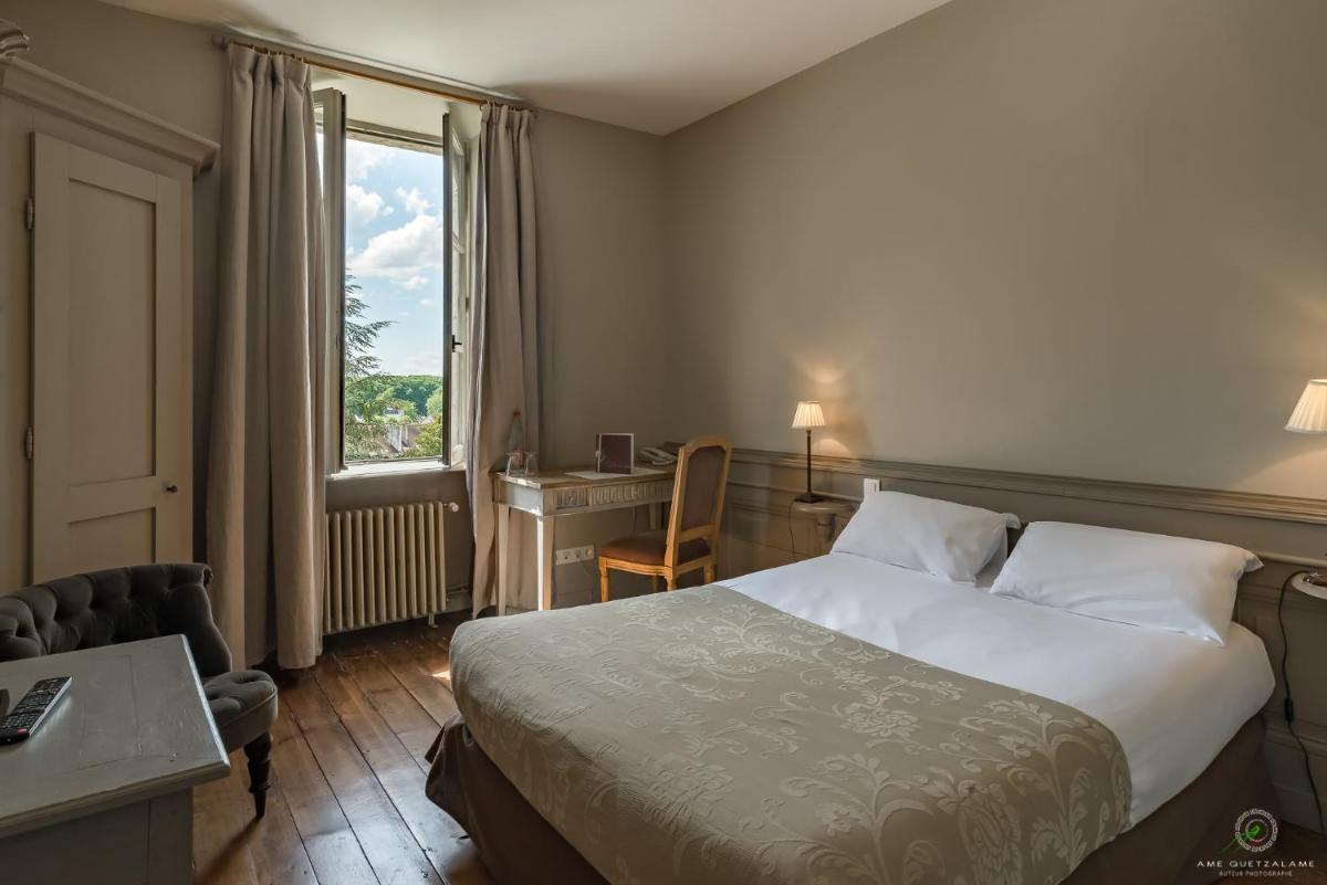 Un ou plusieurs lits dans un hébergement de l'établissement Hôtel Restaurant Spa Le Sauvage