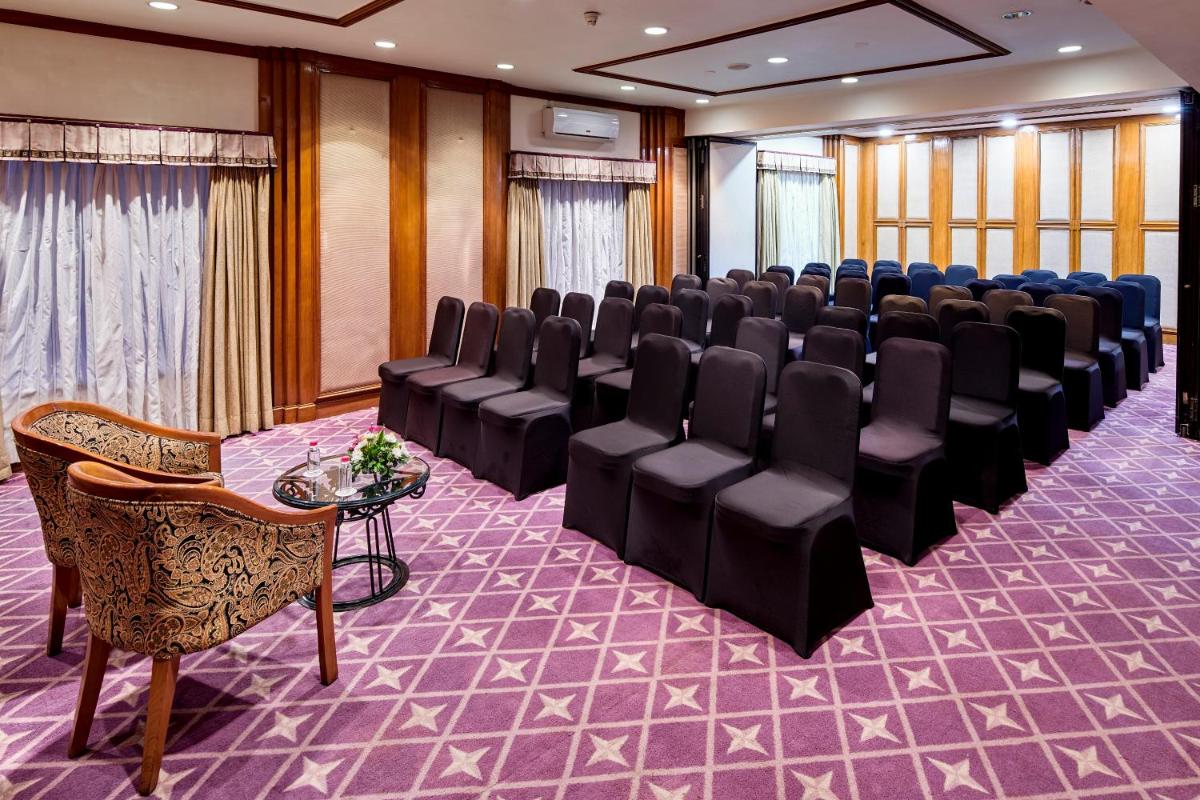 a conference room with a row of chairs and a table at The Ummed Ahmedabad Airport in Ahmedabad