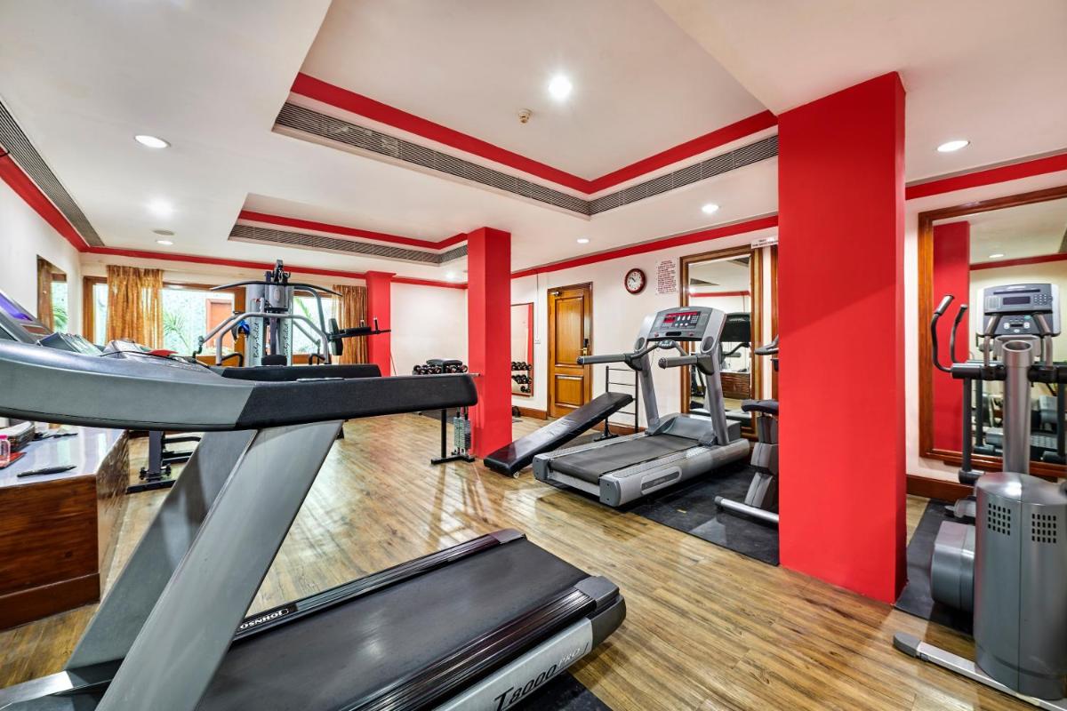 a gym with two treadmills and cardio machines at The Ummed Ahmedabad Airport in Ahmedabad