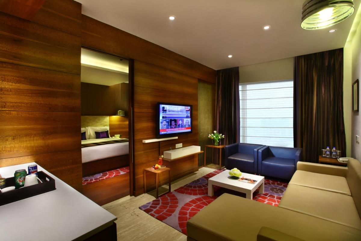 a living room with a couch and a bed at Park Plaza Shahdara in New Delhi a living room with a couch and a bed at Park Plaza Shahdara in New Delhi