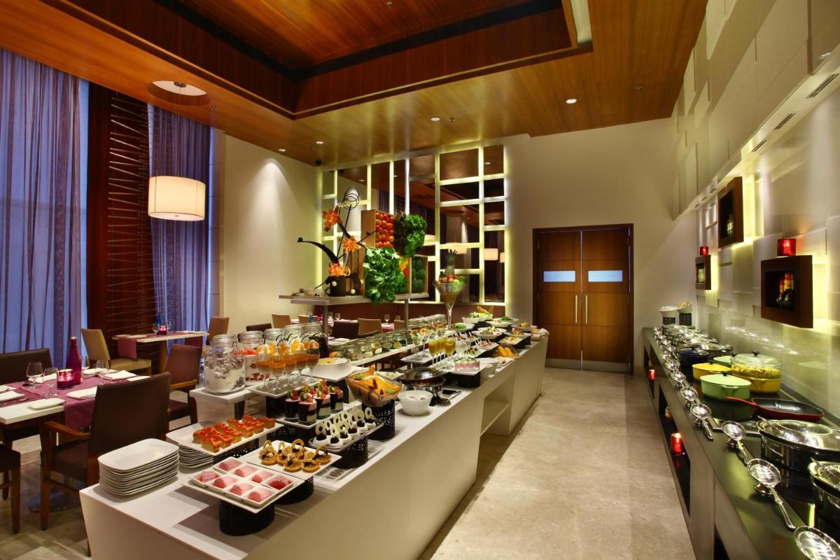 a buffet line with food on display in a restaurant at Park Plaza Shahdara in New Delhi a buffet line with food on display in a restaurant at Park Plaza Shahdara in New Delhi