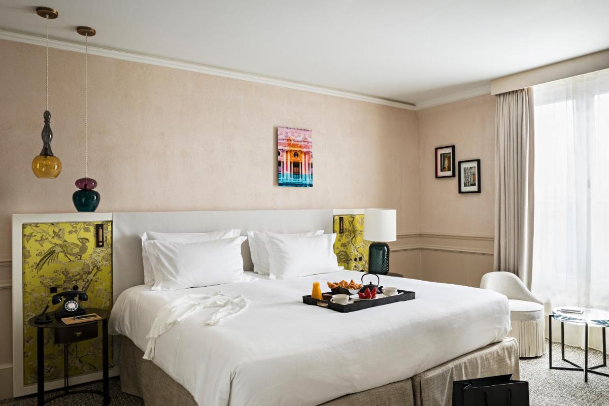 Un ou plusieurs lits dans un hébergement de l'établissement Sofitel Le Scribe Paris Opera