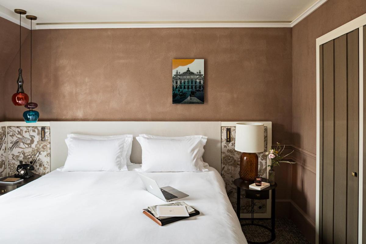 Un ou plusieurs lits dans un hébergement de l'établissement Sofitel Le Scribe Paris Opera