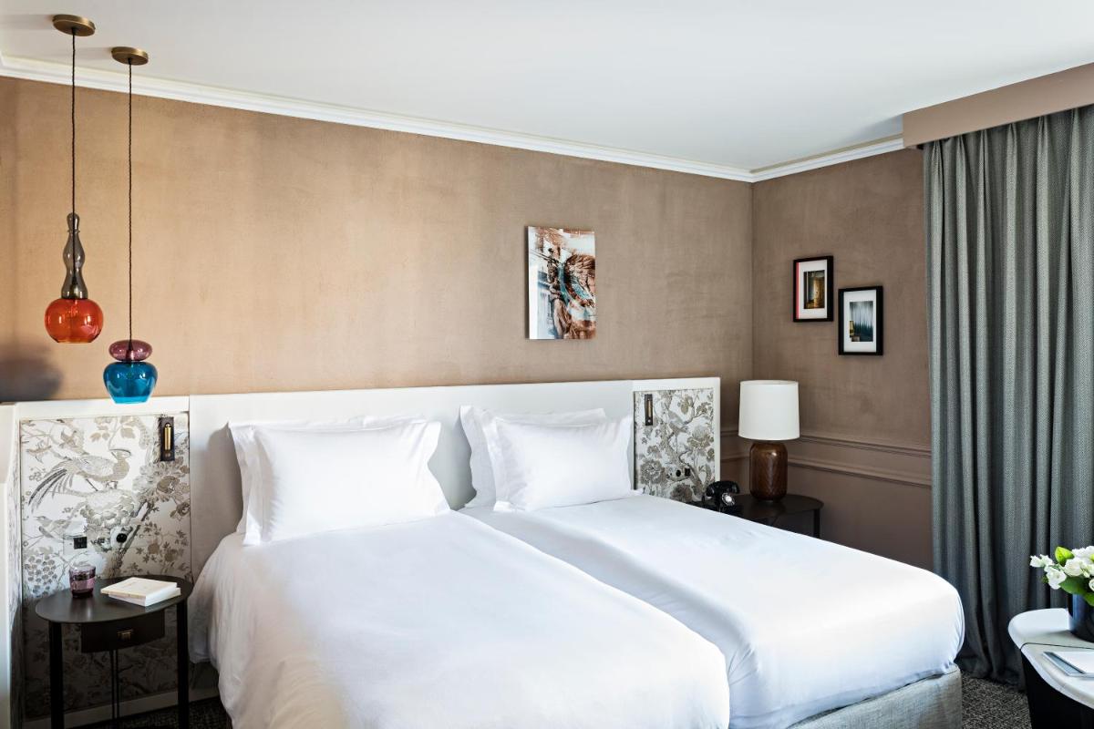 Un ou plusieurs lits dans un hébergement de l'établissement Sofitel Le Scribe Paris Opera