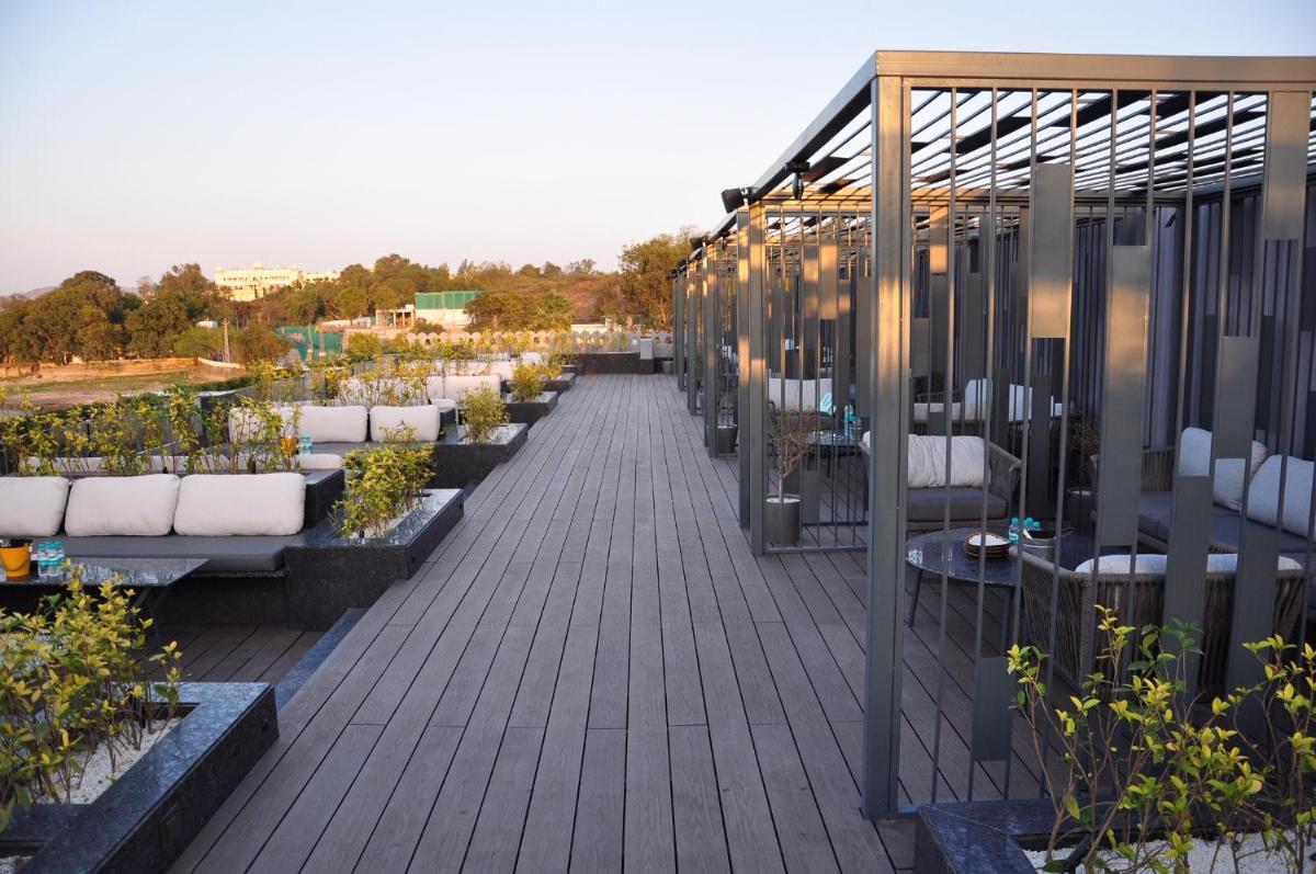 a row of potted plants on a deck at Hotel Lakend in Udaipur
