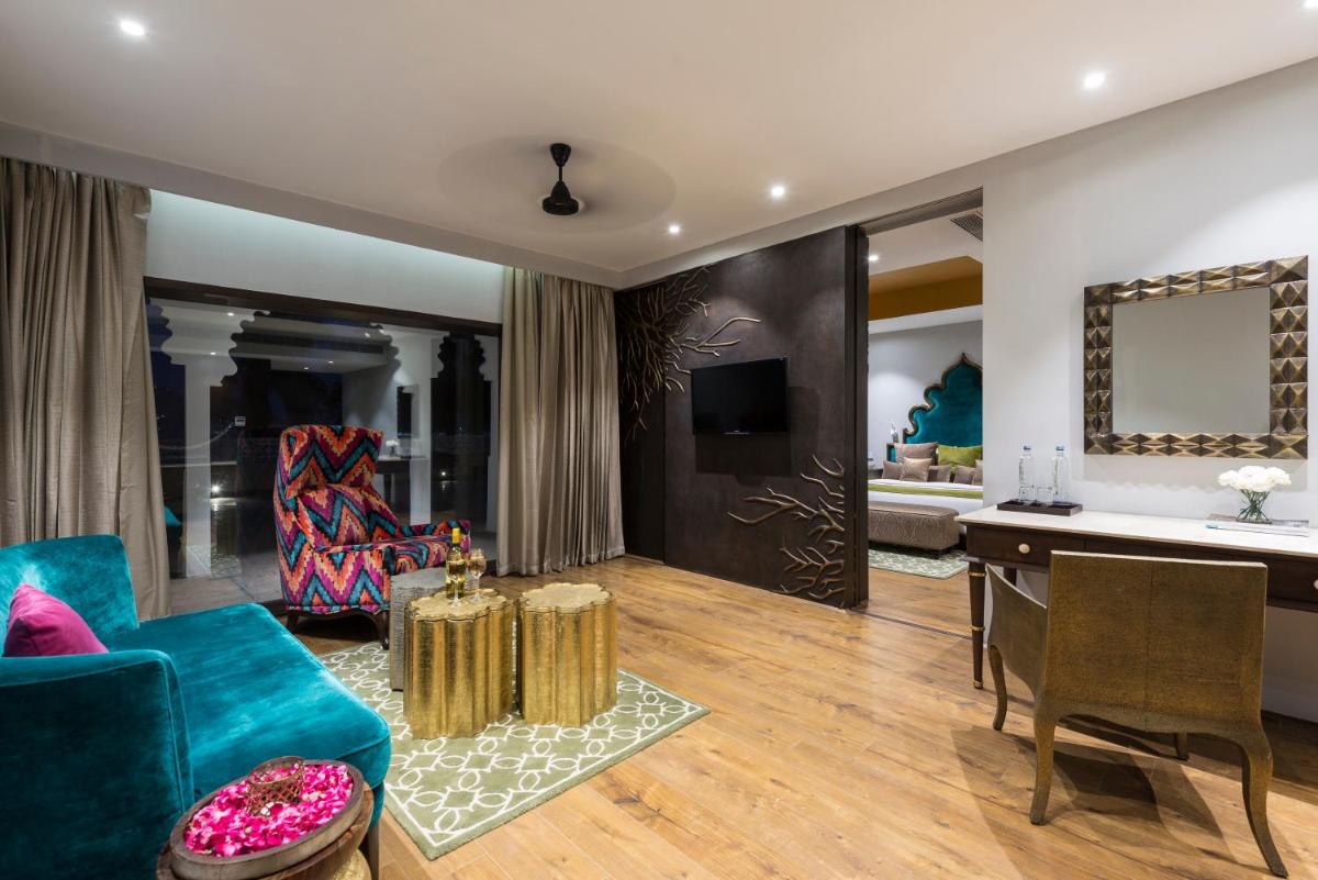 a living room with a couch and a table at Hotel Lakend in Udaipur