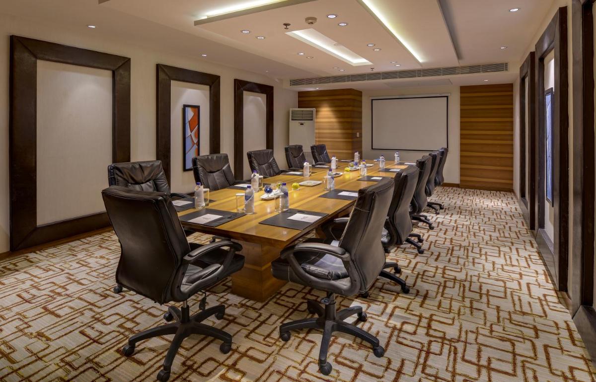 a conference room with a long table and chairs at Pride Plaza Hotel, Kolkata in Kolkata