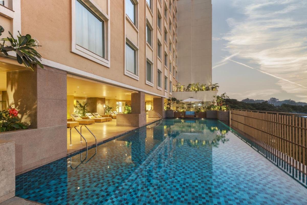 a swimming pool in the middle of a building at Lemon Tree Premier City Center Pune in Pune