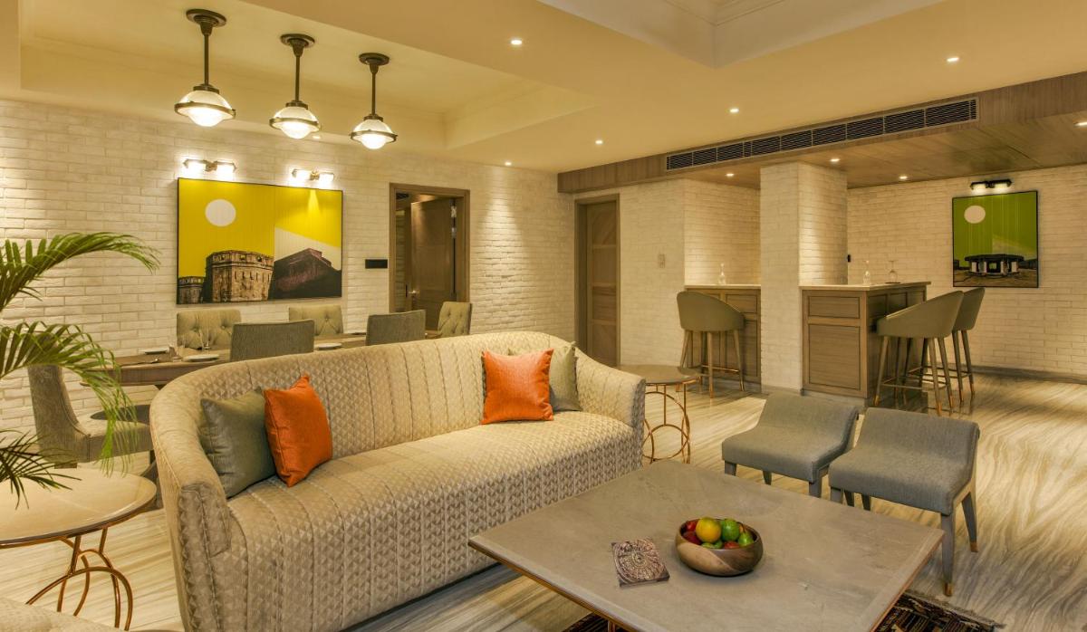 a living room with a couch and a table at Lemon Tree Premier City Center Pune in Pune