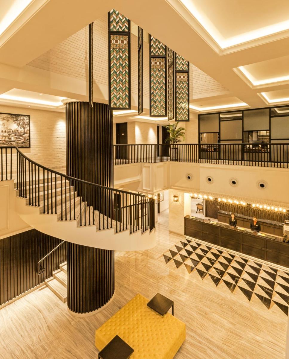 a lobby with a spiral staircase in a building at Lemon Tree Premier City Center Pune in Pune