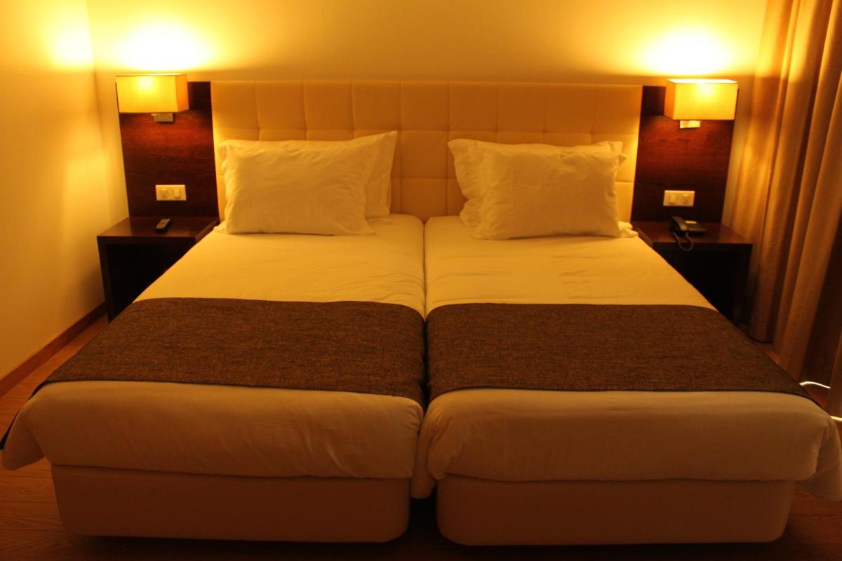Uma cama ou camas num quarto em Hotel O Gato & Spa