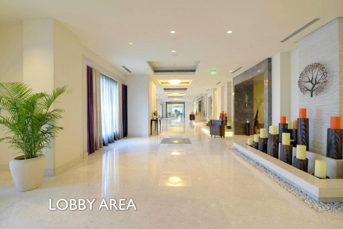 a lobby with a plant in a building at Radisson Blu Bengaluru Outer Ring Road in Bengaluru