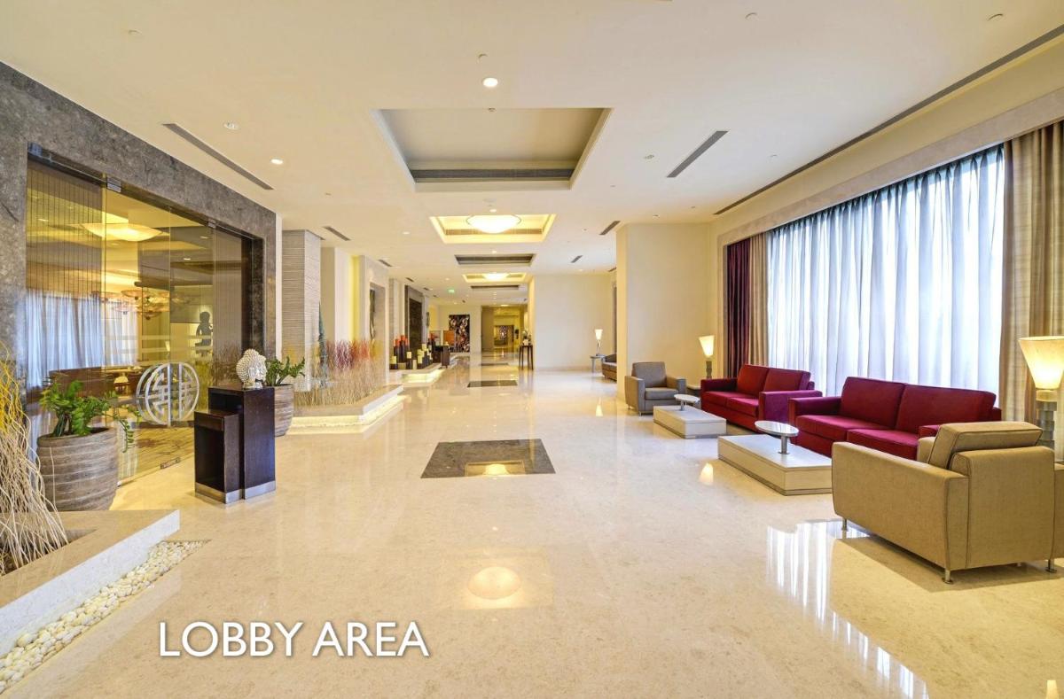 a lobby with couches and chairs in a building at Radisson Blu Bengaluru Outer Ring Road in Bengaluru +53 photos