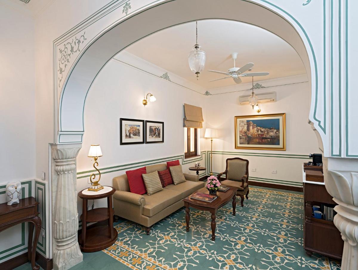 a living room with a couch and a table at Samode Haveli in Jaipur
