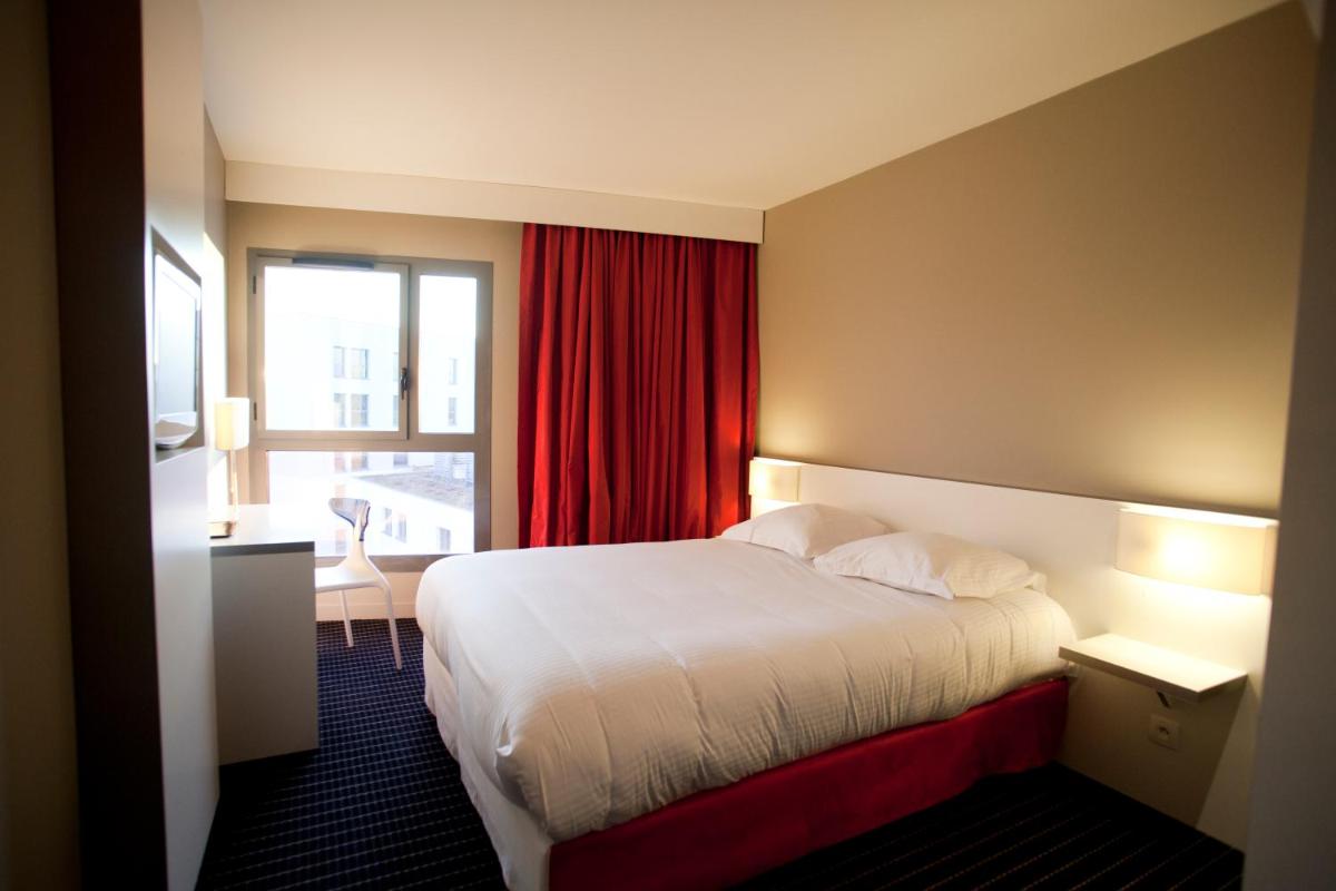 Un ou plusieurs lits dans un hébergement de l'établissement B&B HOME Lyon Centre Berthelot
