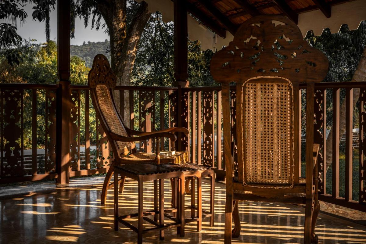 a group of chairs sitting on a porch at The Postcard Cuelim, Goa in Cansaulim