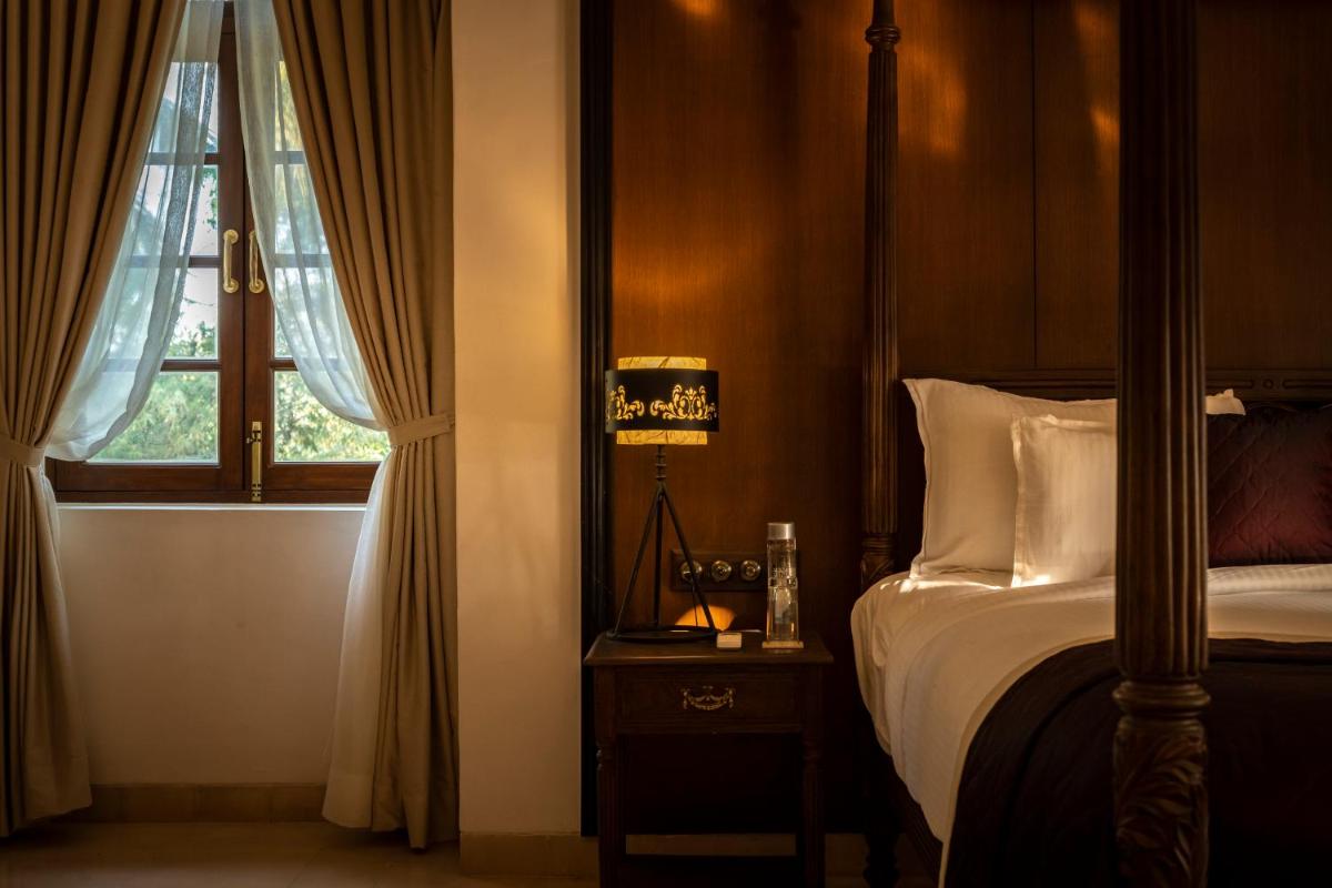 a bedroom with a bed and a window at The Postcard Cuelim, Goa in Cansaulim