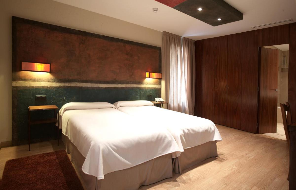 Cama o camas de una habitación en Hotel Santa Cristina Petit Spa