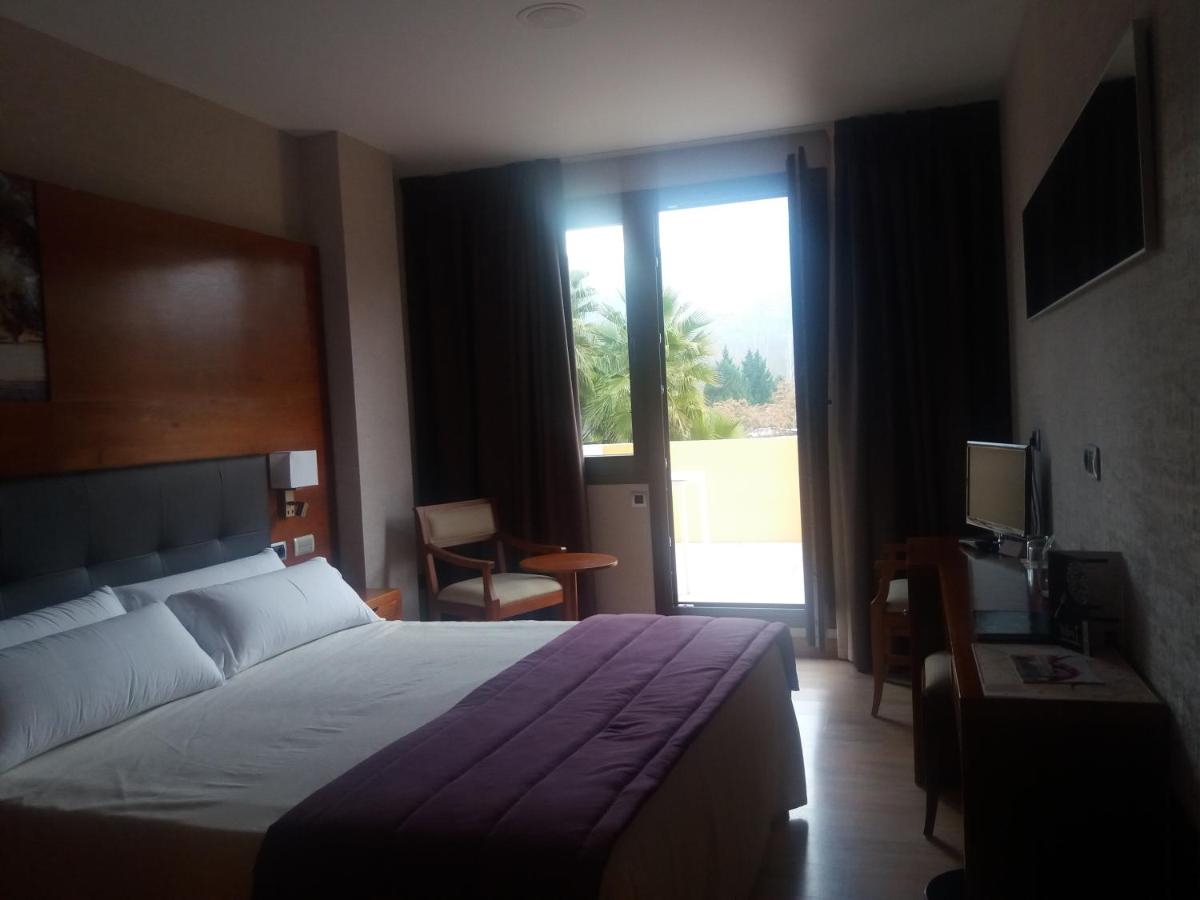 Cama o camas de una habitación en Hotel Balneario Valle del Jerte
