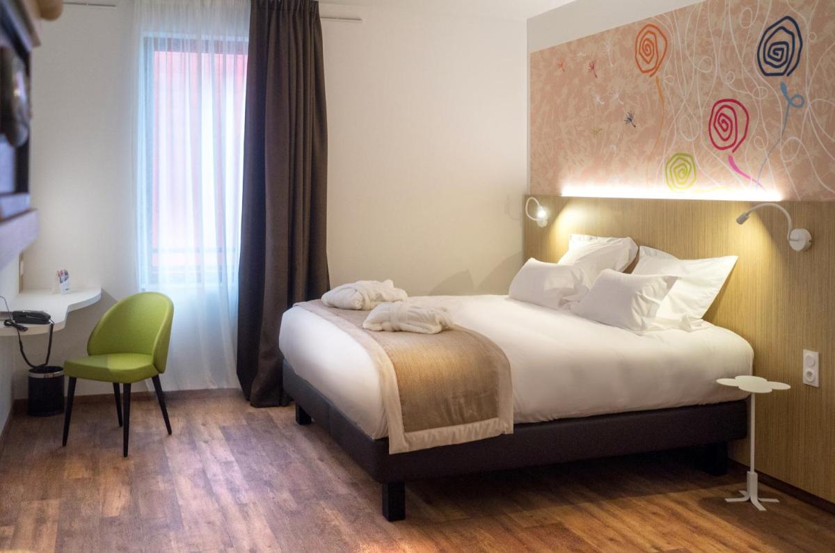 Un ou plusieurs lits dans un hébergement de l'établissement Kyriad Prestige Amiens Poulainville - Hotel and Spa