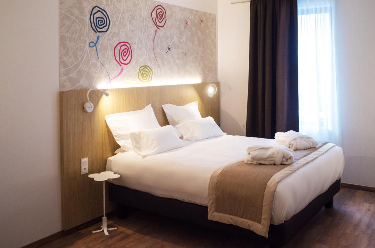 Un ou plusieurs lits dans un hébergement de l'établissement Kyriad Prestige Amiens Poulainville - Hotel and Spa