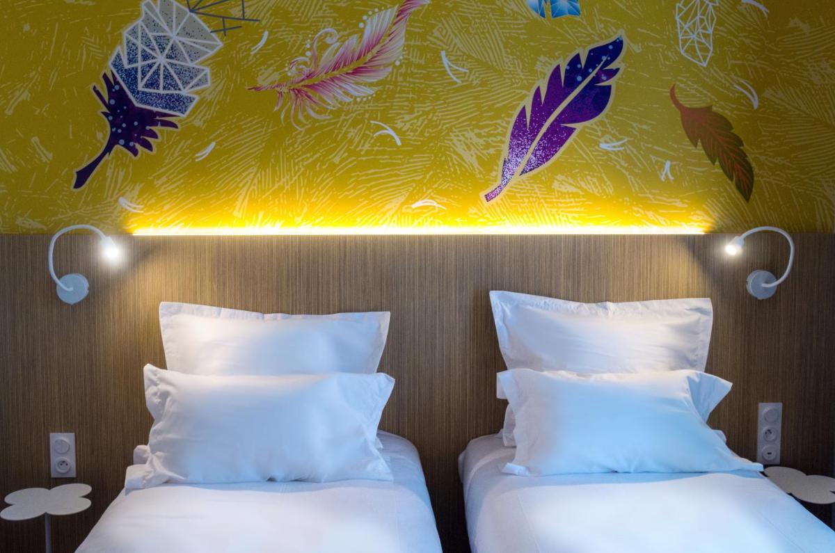 Un ou plusieurs lits dans un hébergement de l'établissement Kyriad Prestige Amiens Poulainville - Hotel and Spa