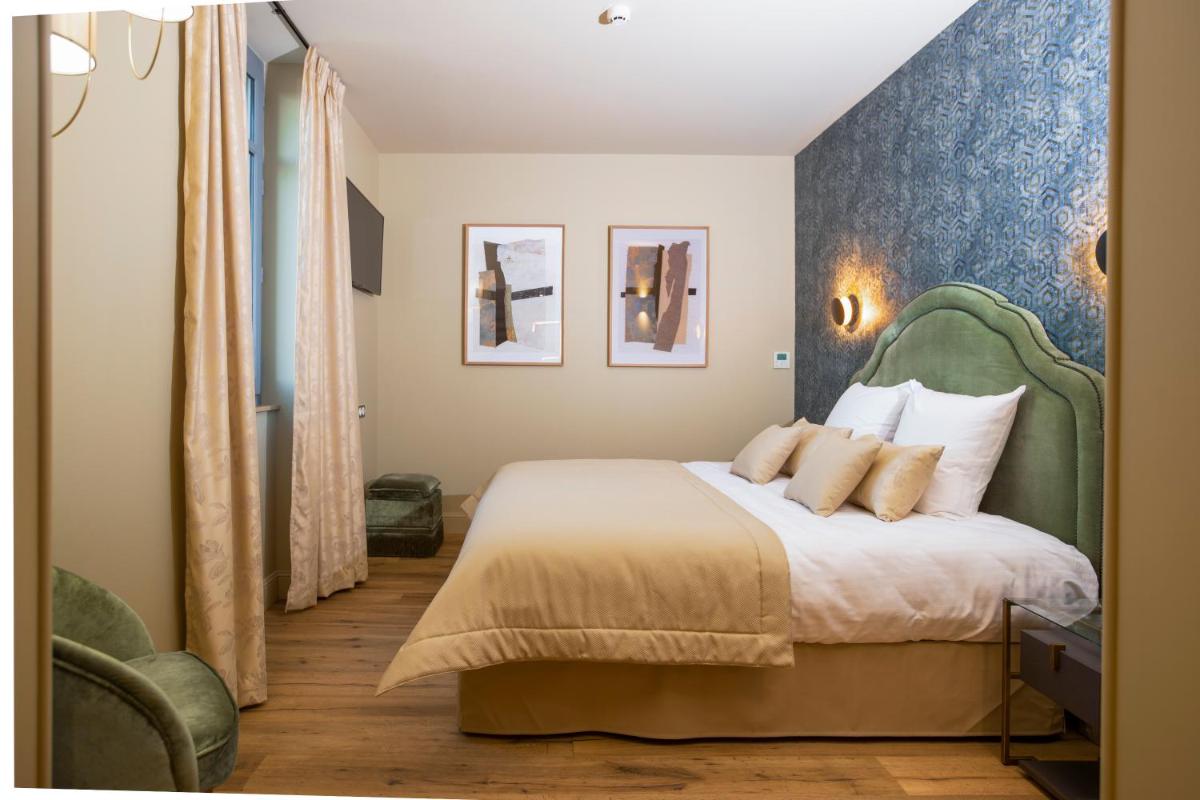 Un ou plusieurs lits dans un hébergement de l'établissement Hotel Clos Castel Villas Spa