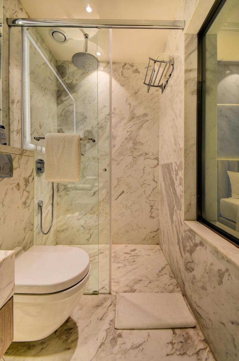 a bathroom with a toilet and a shower at Vividus in Bengaluru a bathroom with a toilet and a shower at Vividus in Bengaluru