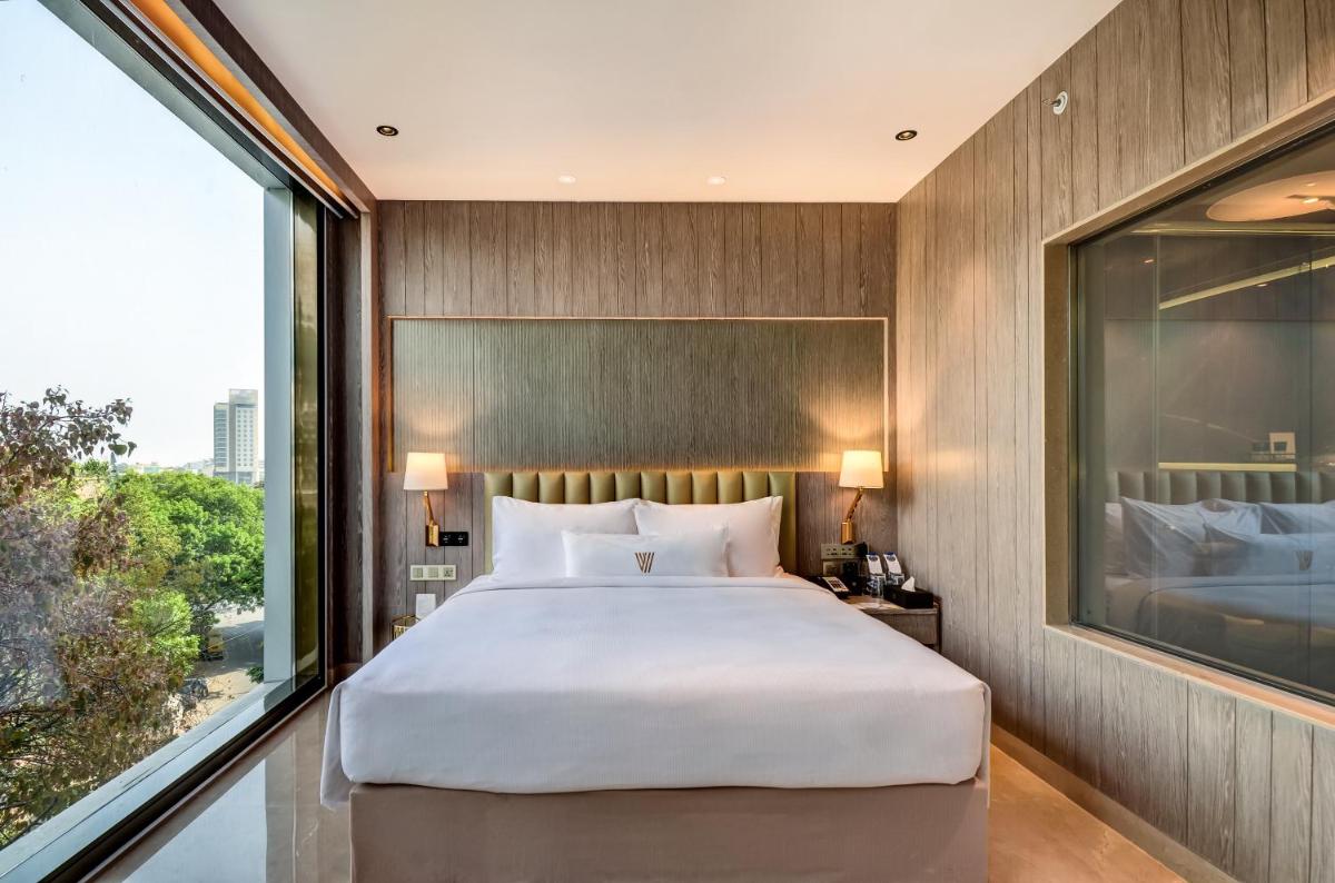a bedroom with a large bed and a large window at Vividus in Bengaluru +58 photos a bedroom with a large bed and a large window at Vividus in Bengaluru +58 photos