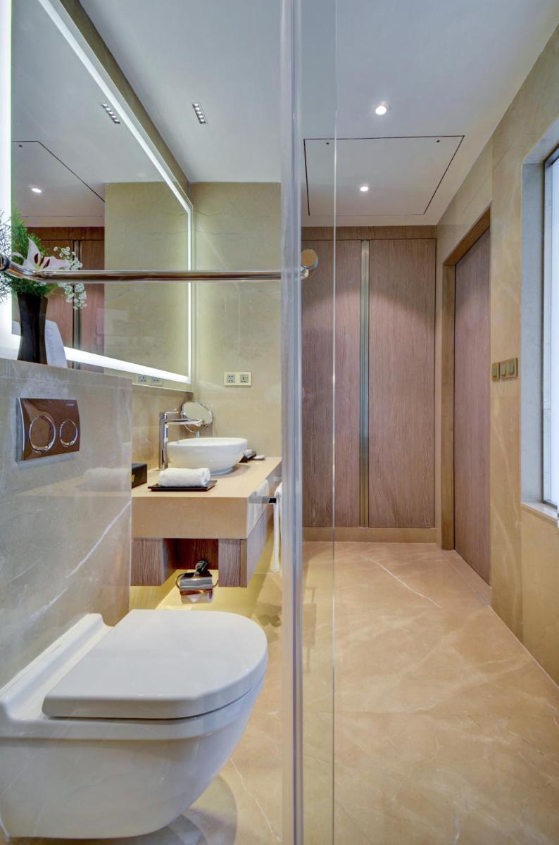 a bathroom with a toilet and a sink at Vividus in Bengaluru a bathroom with a toilet and a sink at Vividus in Bengaluru