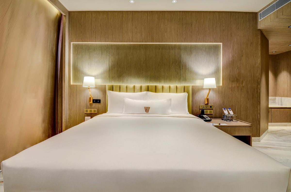 a large white bed in a hotel room at Vividus in Bengaluru a large white bed in a hotel room at Vividus in Bengaluru