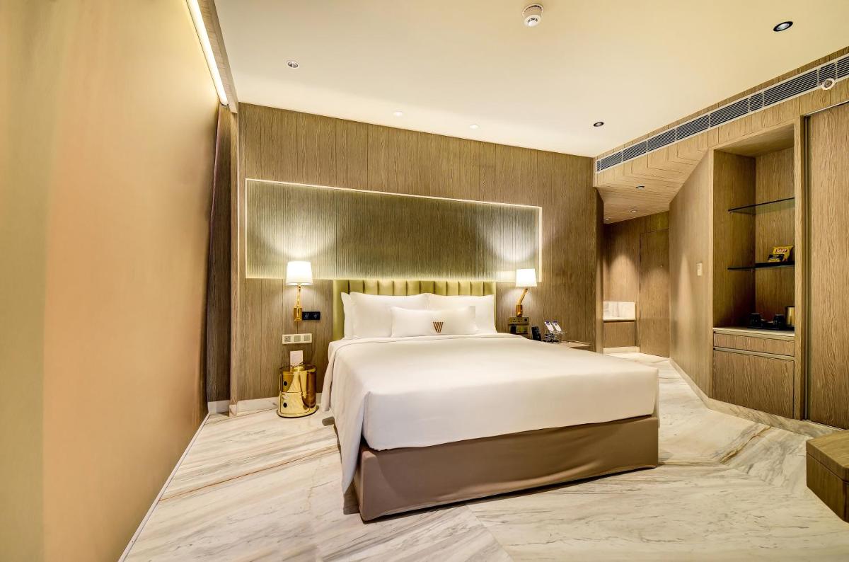 a bedroom with a large white bed in a room at Vividus in Bengaluru a bedroom with a large white bed in a room at Vividus in Bengaluru