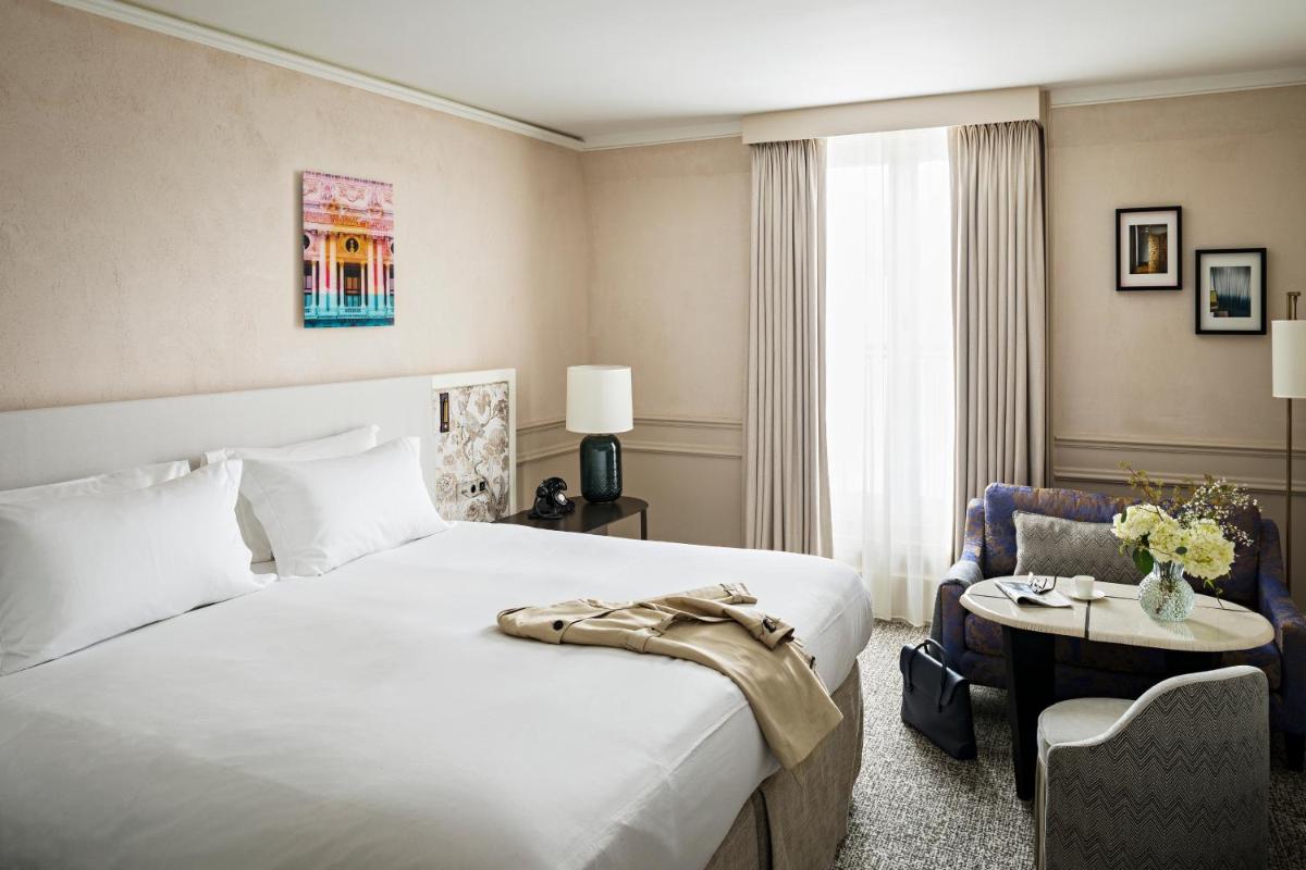 Un ou plusieurs lits dans un hébergement de l'établissement Sofitel Le Scribe Paris Opera